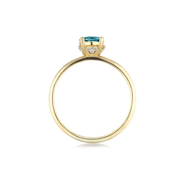 Teal sapphire ring with diamonds set in 18K yellow gold