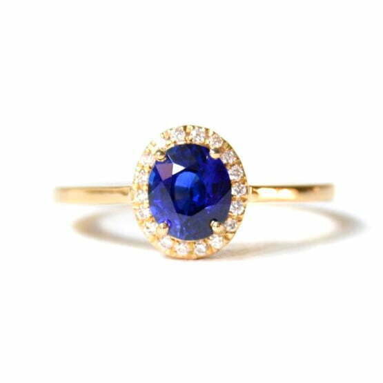 Blue sapphire halo ring with diamonds set in 18k yellow gold