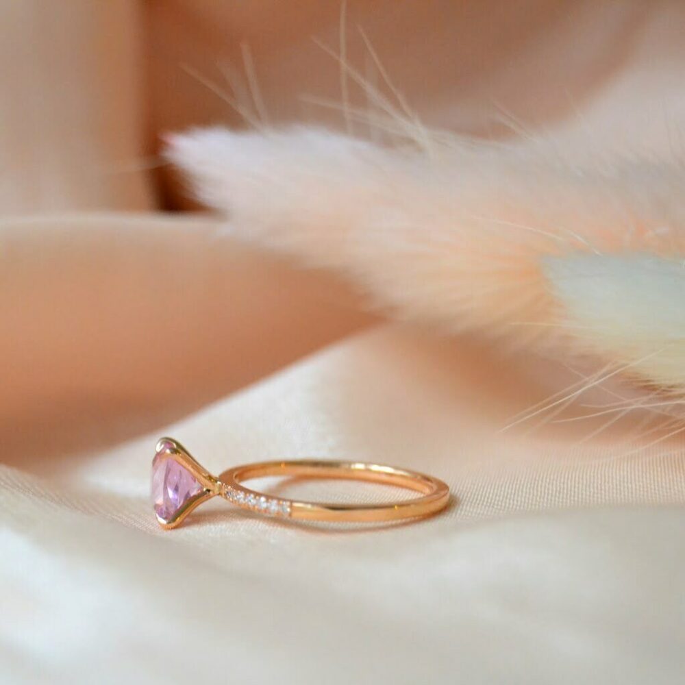 Radiant cut pink sapphire ring with diamonds set in 18K rose gold