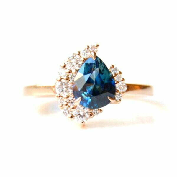 Teal pear sapphire ring with diamonds set in 18k rose gold