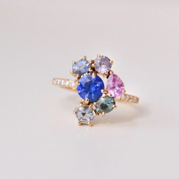 Blue sapphire ring with diamonds and a cluster of sapphires