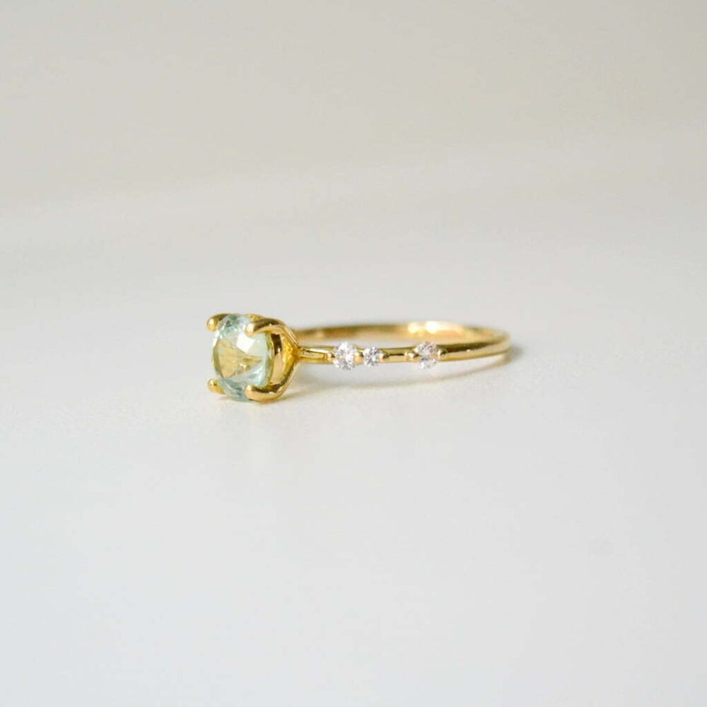 Green tourmaline solitaire ring with diamonds in yellow gold ring