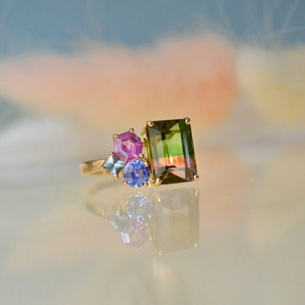 Bi-color tourmaline ring with sapphires set in 18K yellow gold