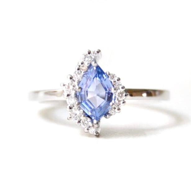 Ring with light blue sapphire set with diamonds in 18K white gold