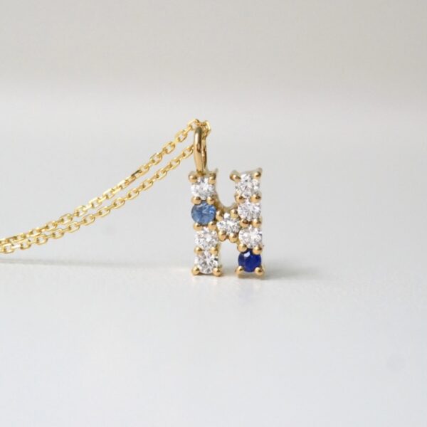 Letter pendant with sapphires