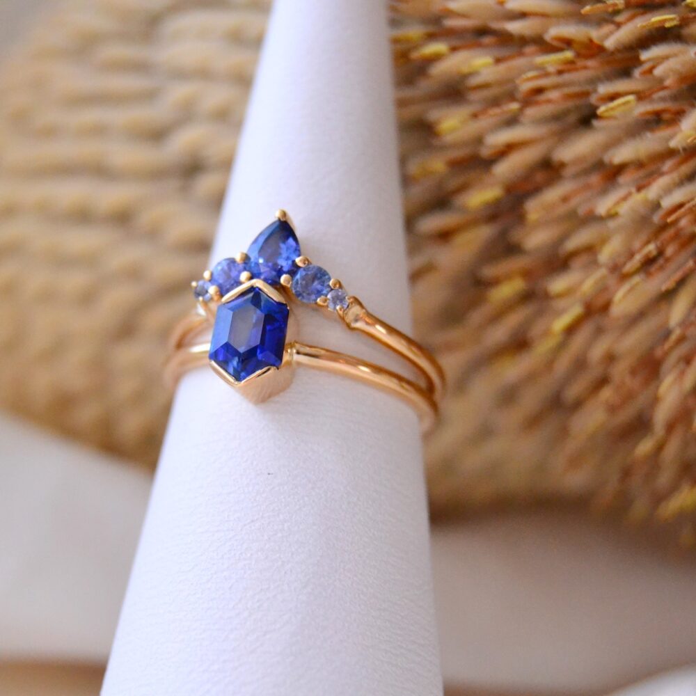 Bi-color blue sapphire ring stack in 18k yellow gold
