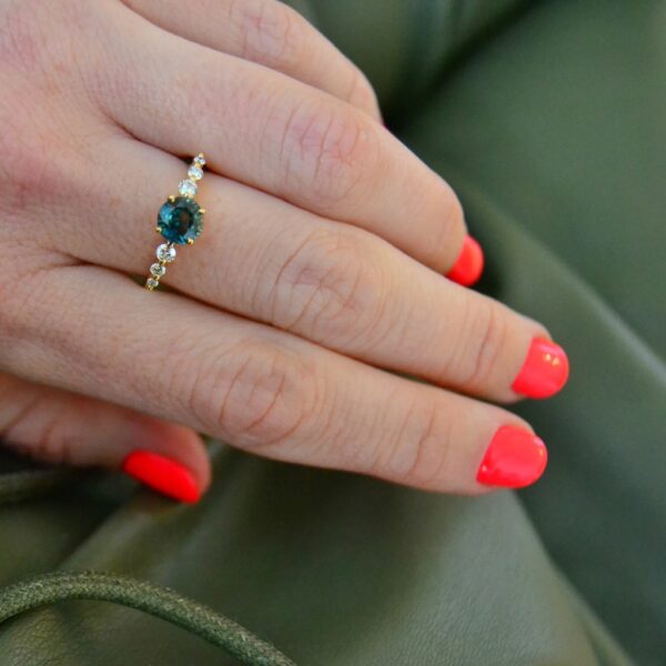 Round teal sapphire and diamond ring