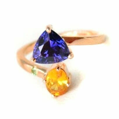 Color changing sapphire ring with orange sapphire