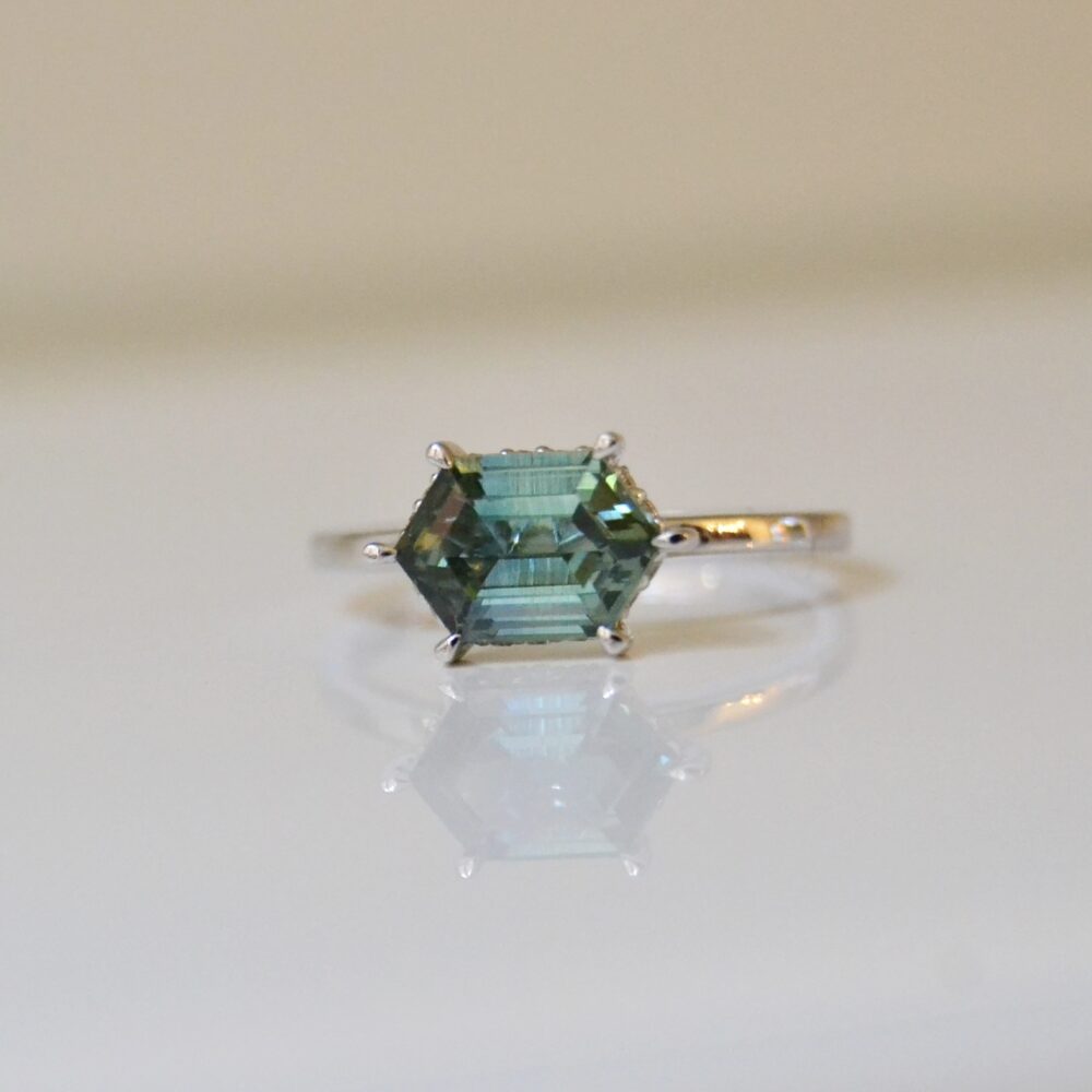 Green sapphire ring with a hidden halo of diamonds set in 18K white gold