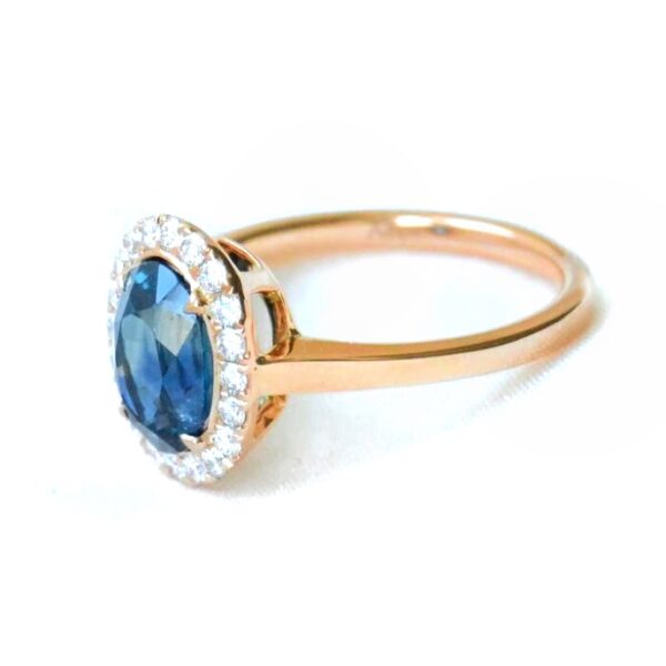 Teal sapphire halo ring with diamonds