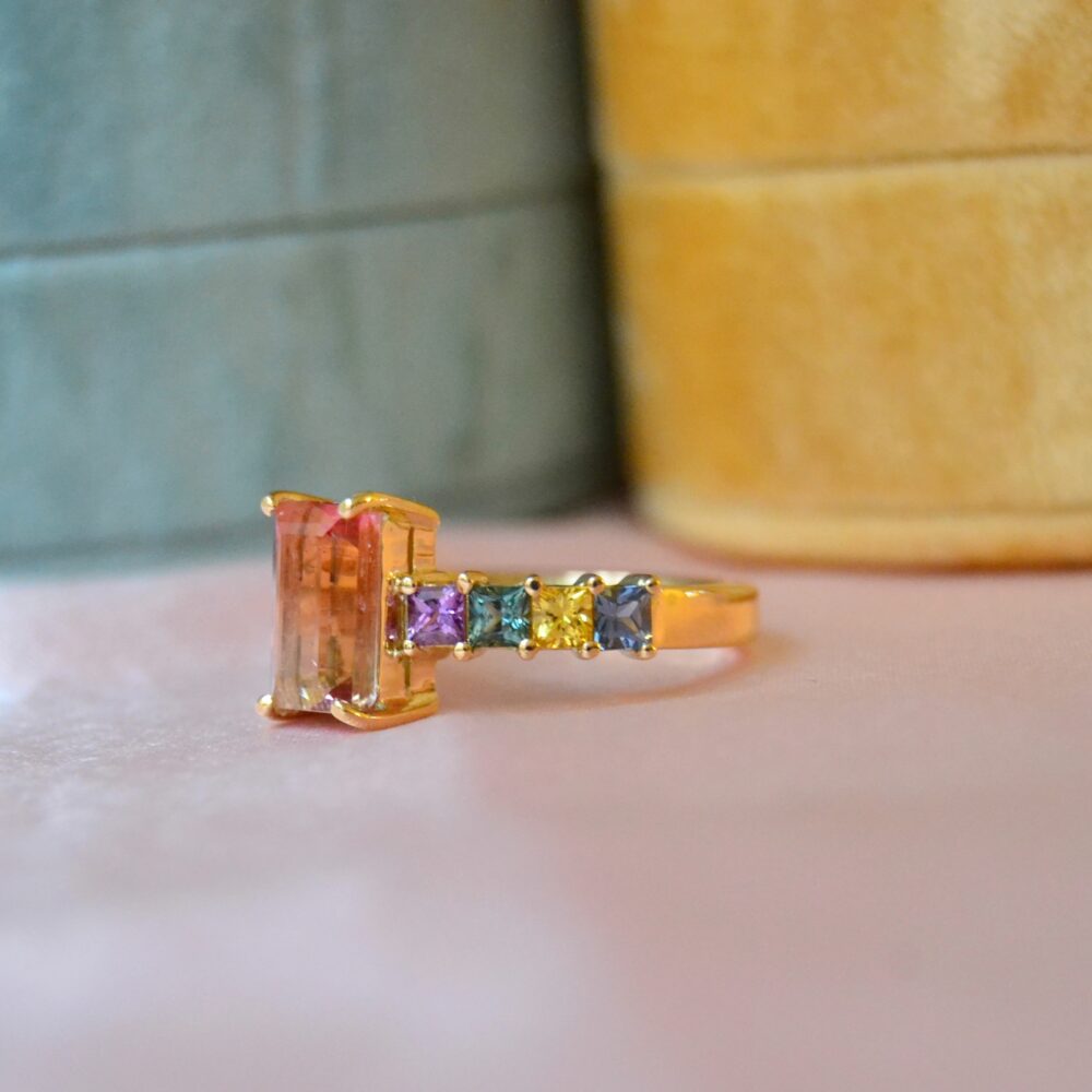Bi-color tourmaline ring with sapphires set in 18K yellow gold