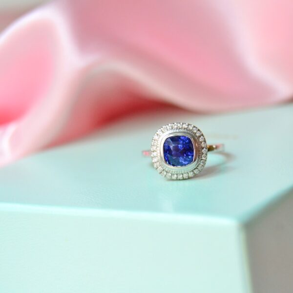 Cornflower blue sapphire halo ring with diamonds