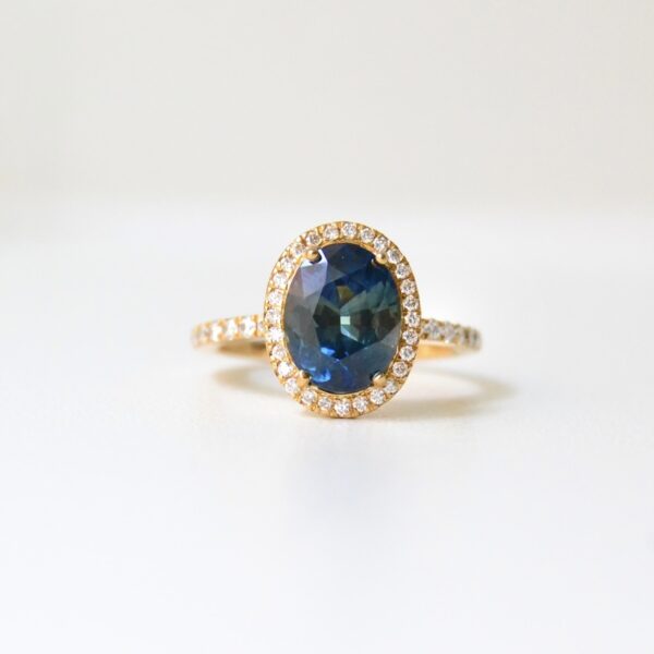 Color changing sapphire ring with a halo of diamonds