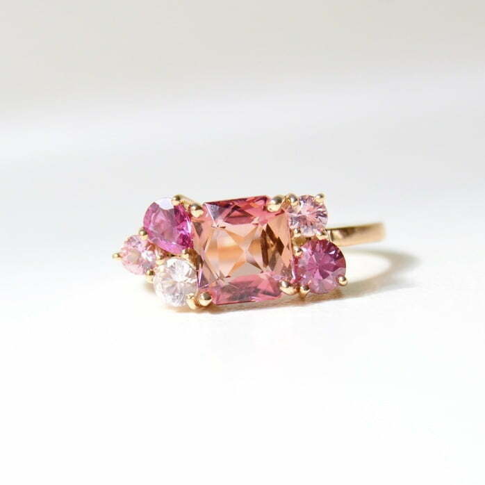 Bi-color tourmaline cluster ring with sapphires set in 18K rose gold.