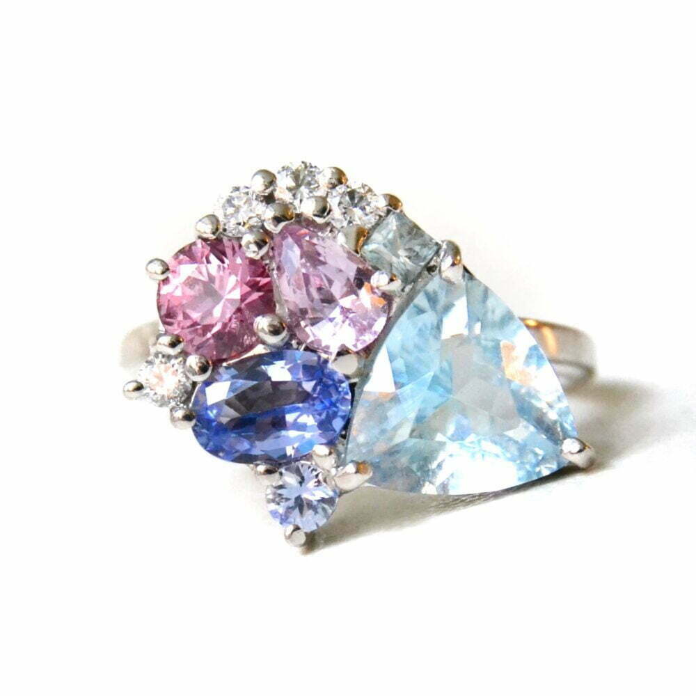 Aquamarine cluster ring with sapphires and diamonds set in 18k white gold.