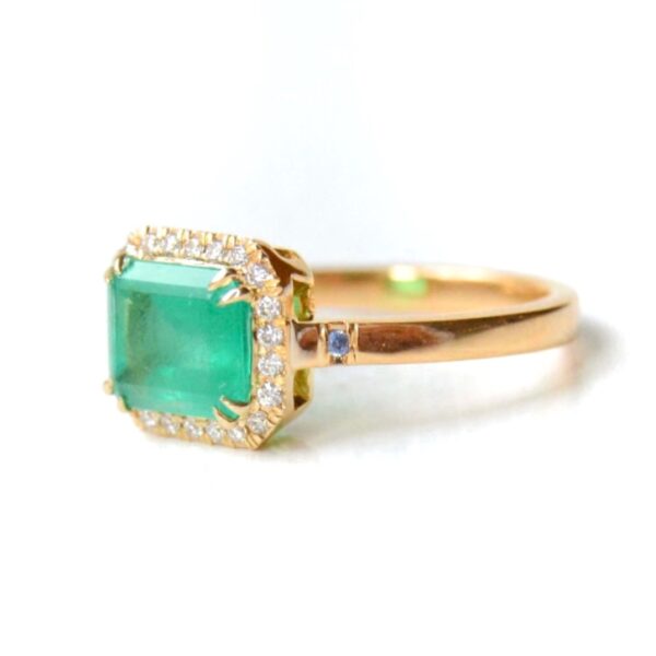 east west ring with emerald and diamonds