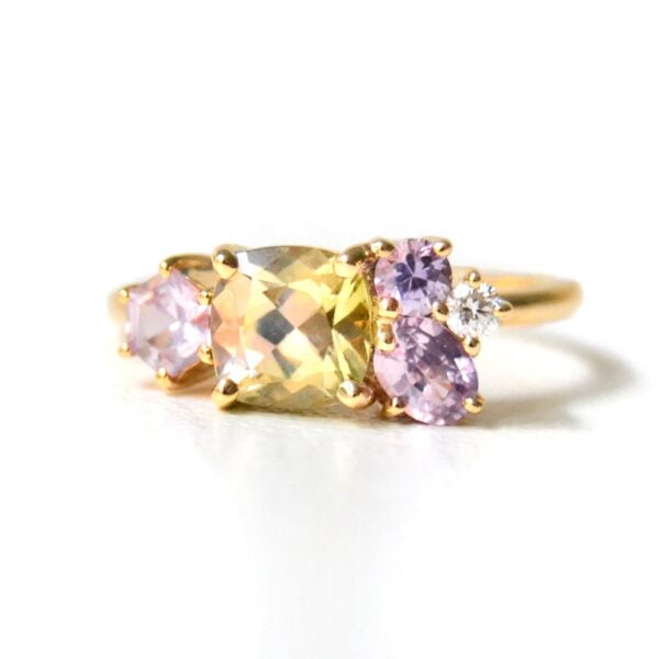 Cushion shaped tourmaline ring in a cluster design with sapphires and diamond set in 18K yellow gold