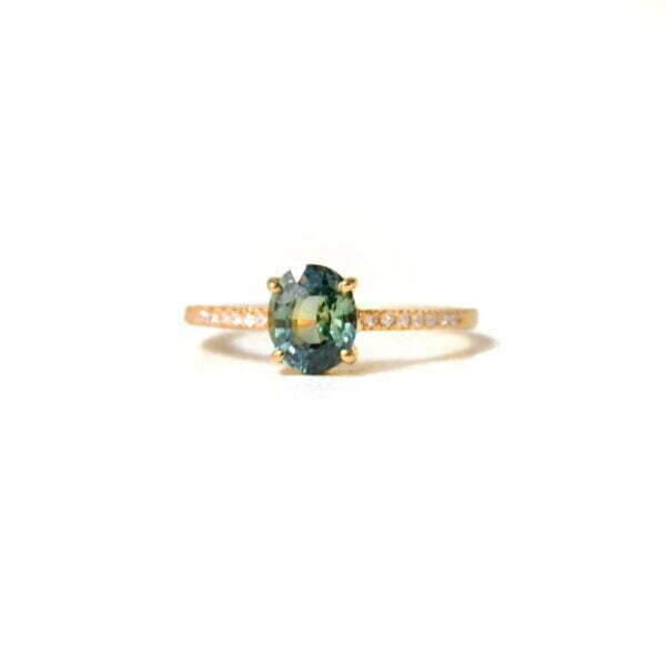 Teal sapphire ring with diamonds set in 18k yellow gold