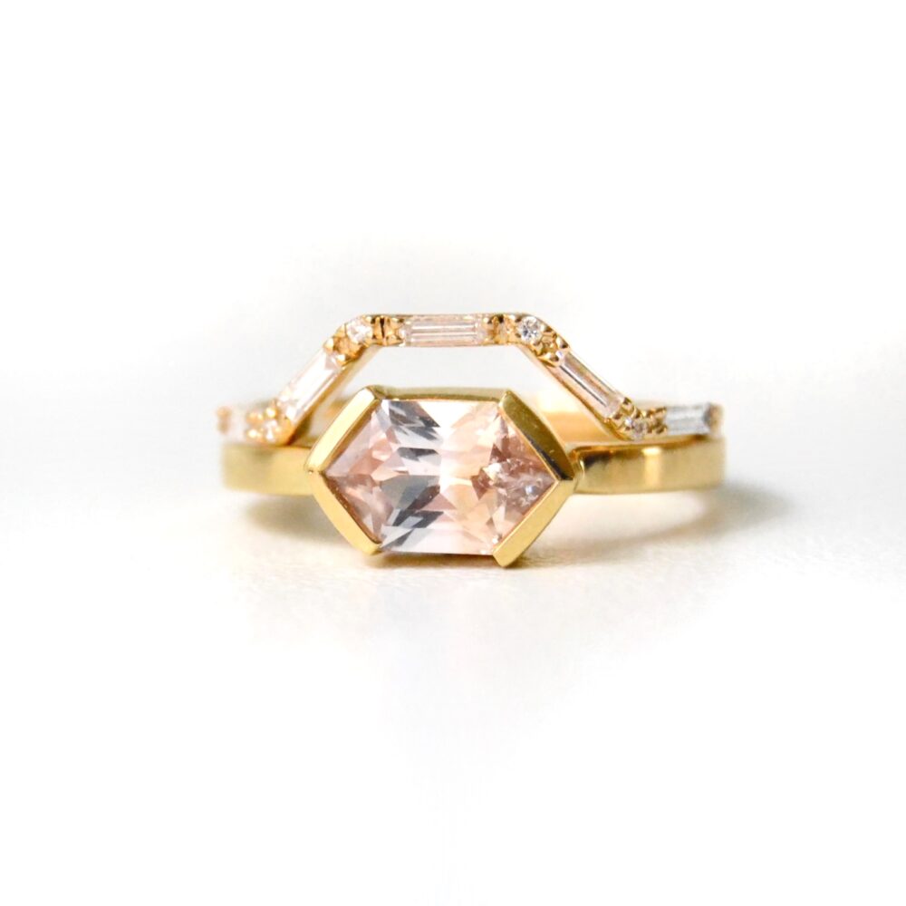 Peach sapphire ring stack with a baguette diamond ring made of 18K yellow gold