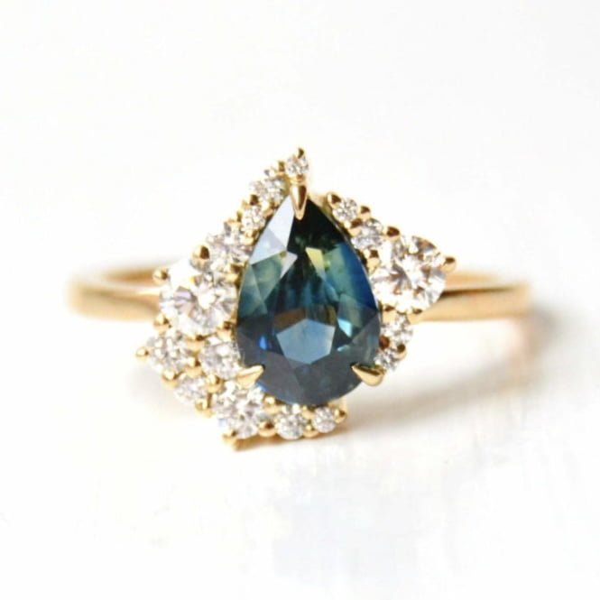 teal sapphire ring with diamonds set in 18k yellow gold