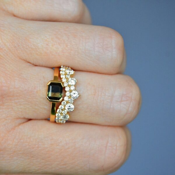 Bi-color sapphire ring stack with loads of diamonds made of yellow gold.