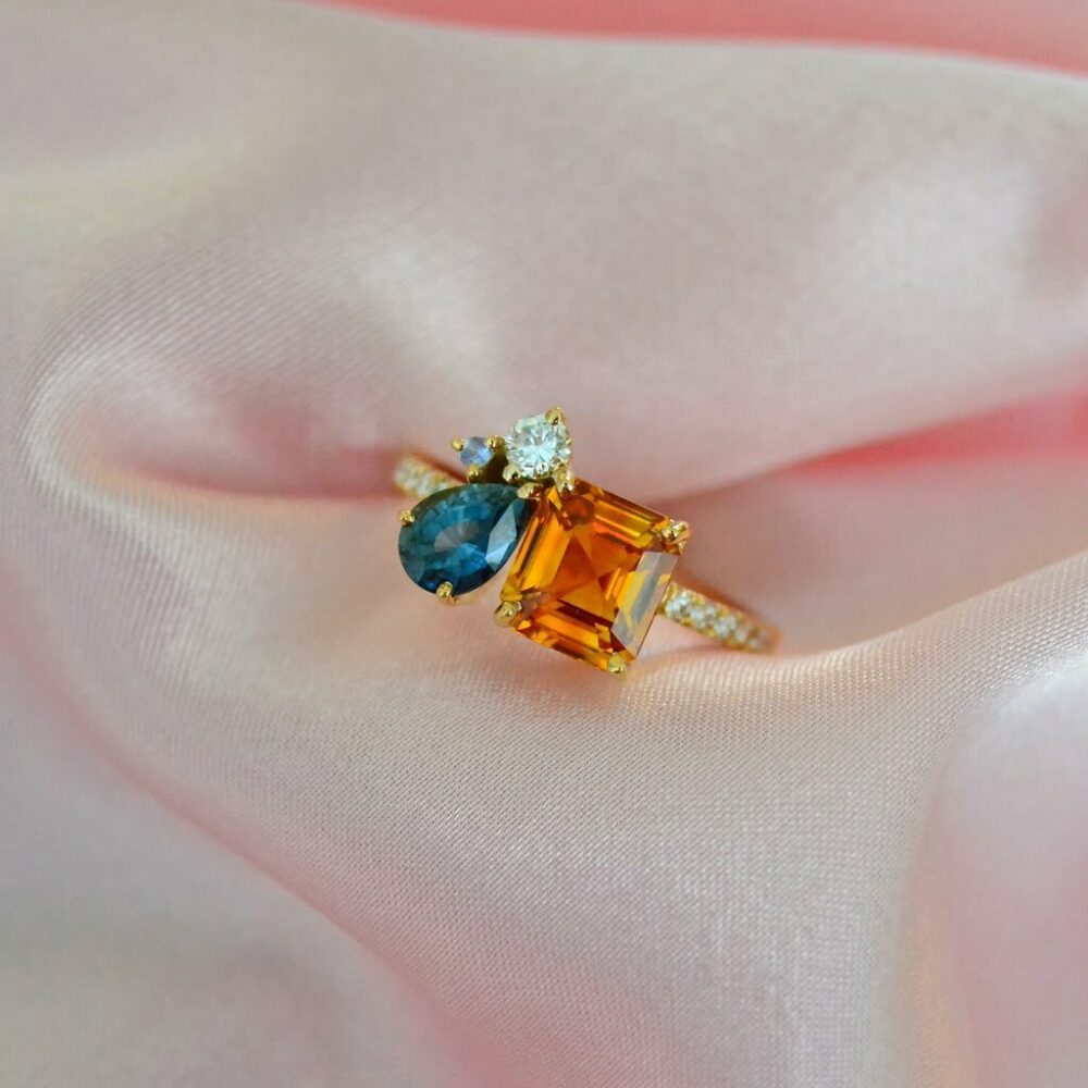 Orange sapphire ring with teal sapphire and diamonds