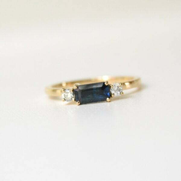 Teal sapphire east west ring