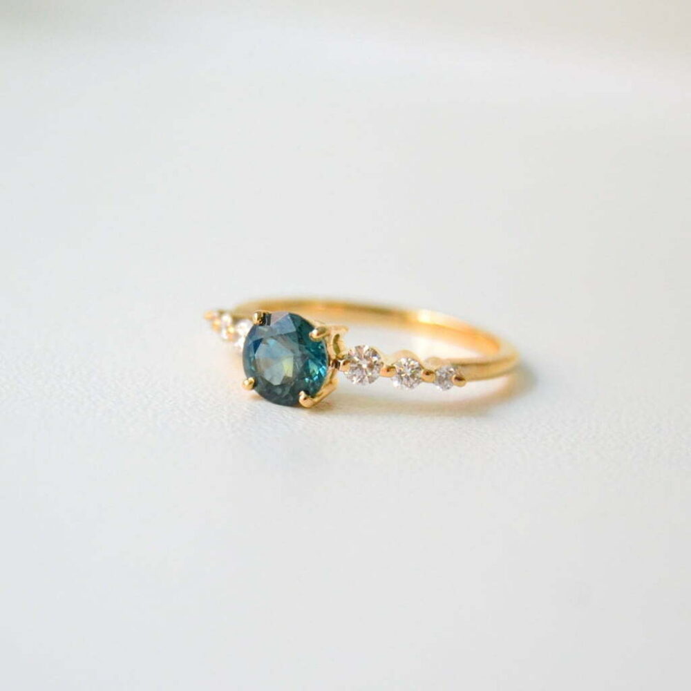 Round teal sapphire and diamond ring