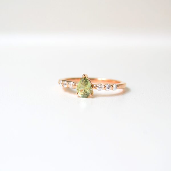 Green sapphire ring with diamonds set in 18K yellow gold.
