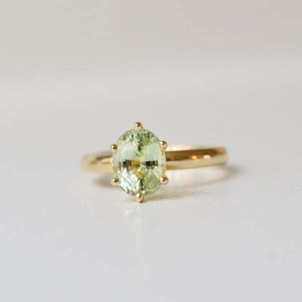 2ct oval green tourmaline ring made of 18K yellow gold and set in a solitaire design.