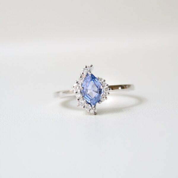 Light blue sapphire ring with diamonds set in white gold