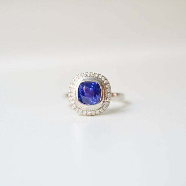 Cornflower blue sapphire halo ring with diamonds