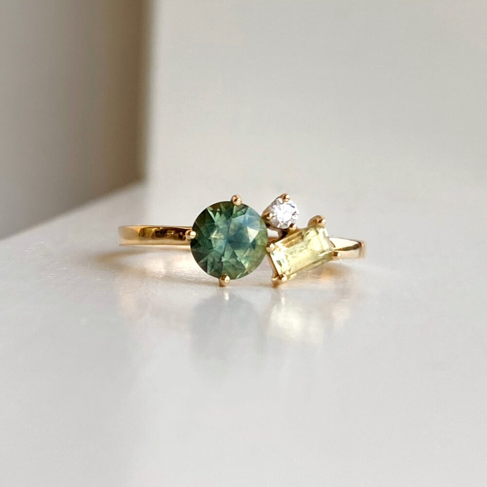 sapphire cluster ring with green and yellow sapphires and diamond set in 18K yellow gold.