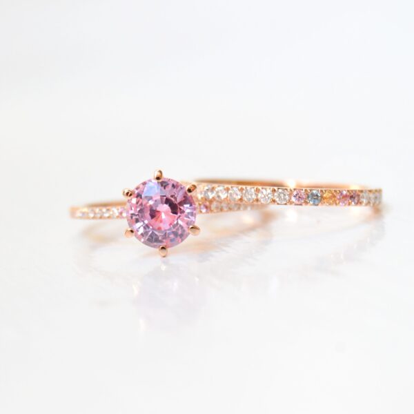 Pink wedding stack with diamonds and other sapphires set in 18K rose gold.