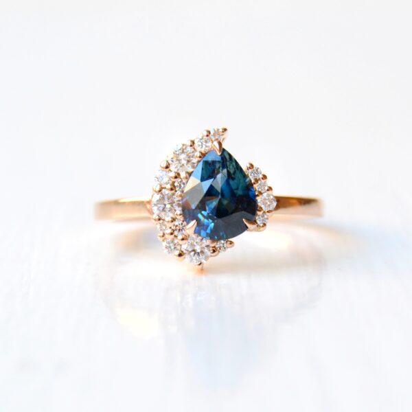 Pear sapphire ring with diamonds set in 18K rose gold.