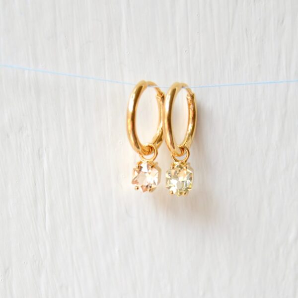 pastel sapphire charms in yellow gold.