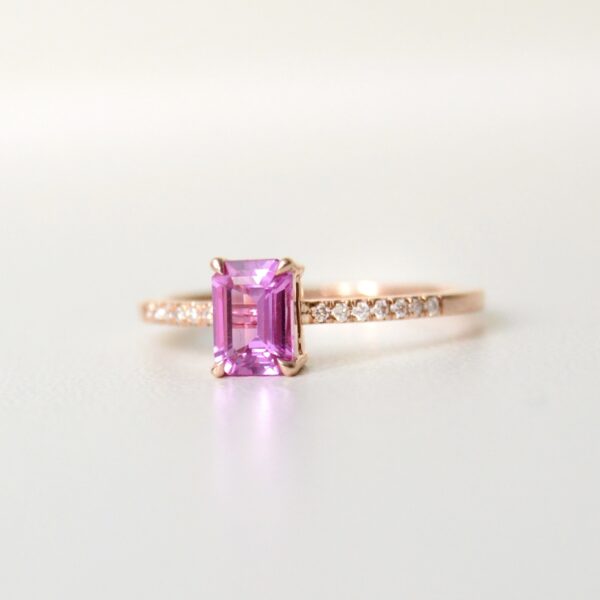 emerald cut pink sapphire ring with diamonds set in 18K rose gold