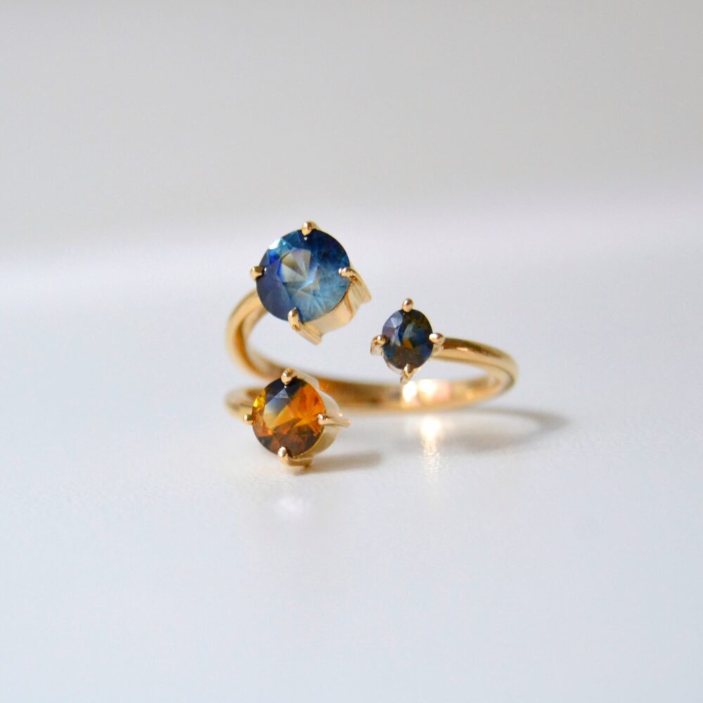 Three stone ring with bi-color sapphires