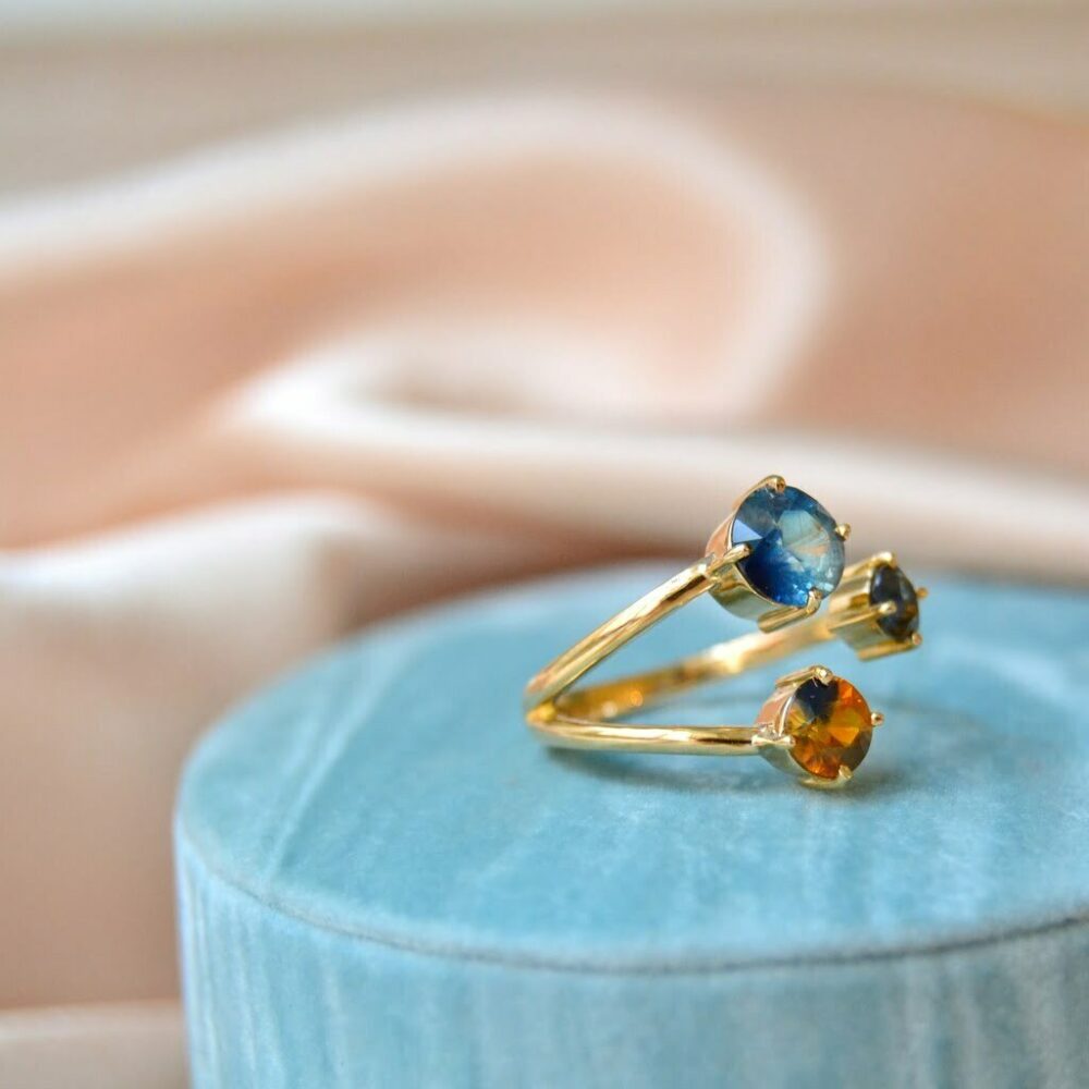 Three stone ring with bi-color sapphires