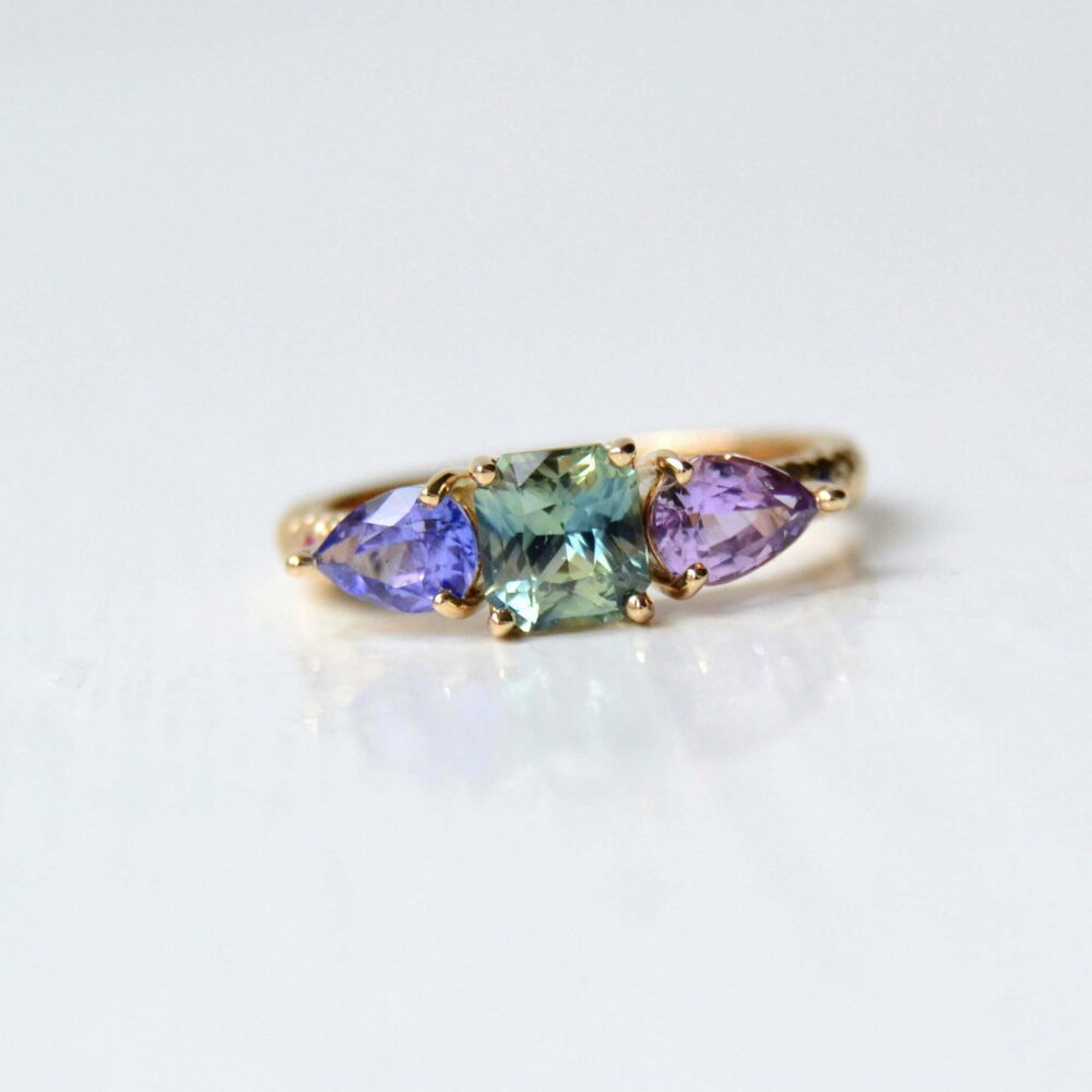 colorful three stone ring with sapphires set in 18K yellow gold.