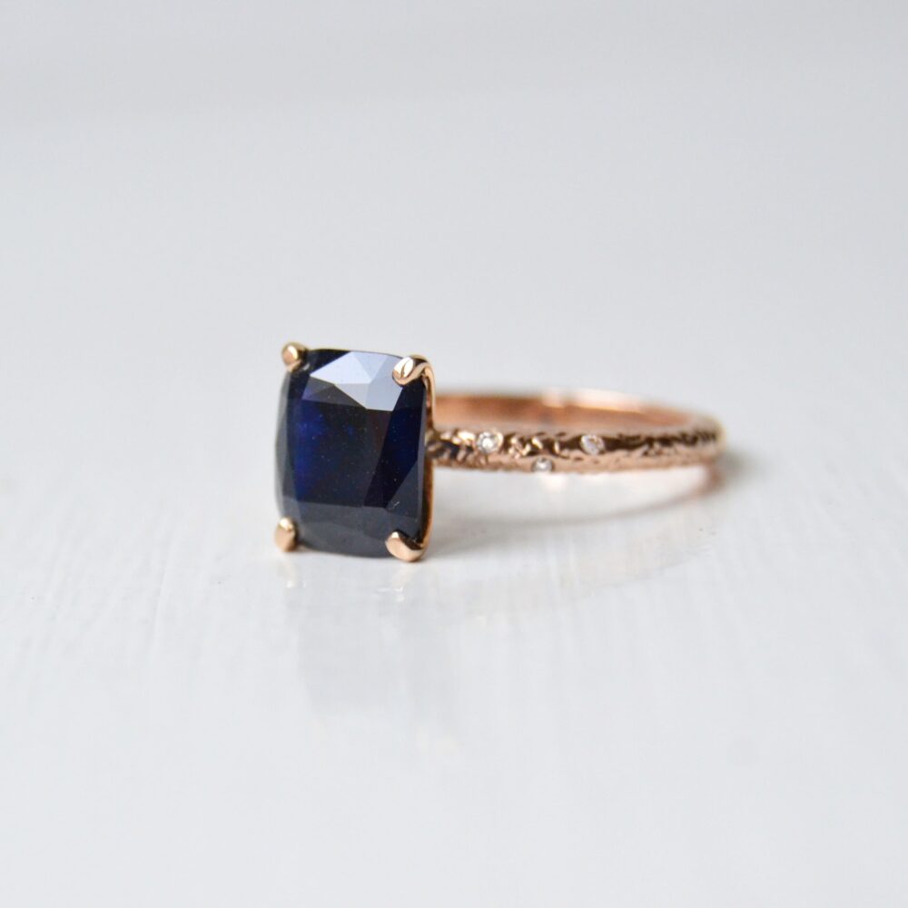 black sapphire ring with heirloom diamonds set in 18K rose gold.