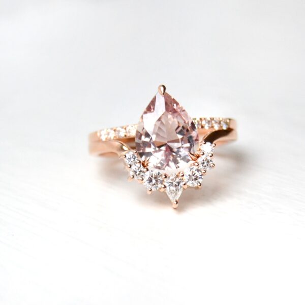 Peach sapphire ring stack with diamonds set in 18K rose gold.