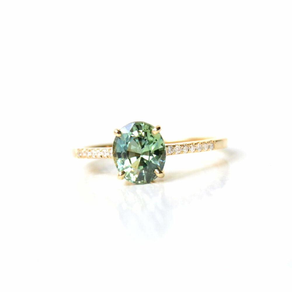 Oval green sapphire ring with diamonds set in 18K yellow gold