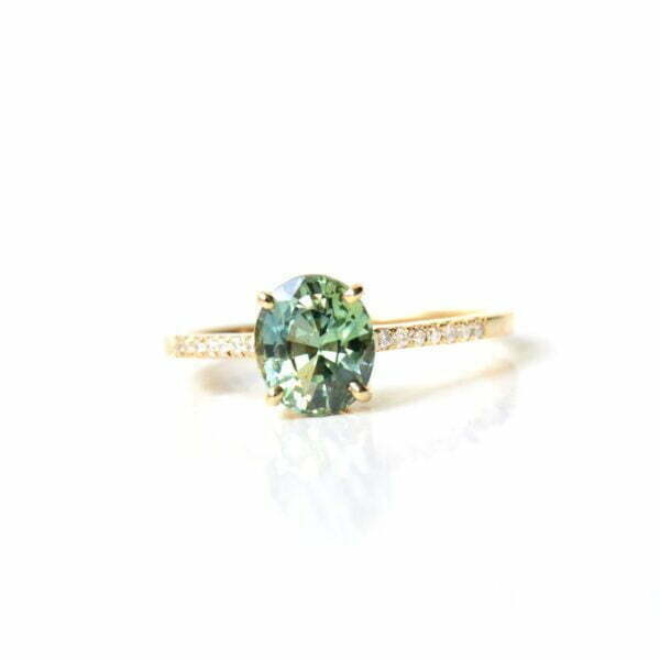 Oval green sapphire ring with diamonds set in 18K yellow gold