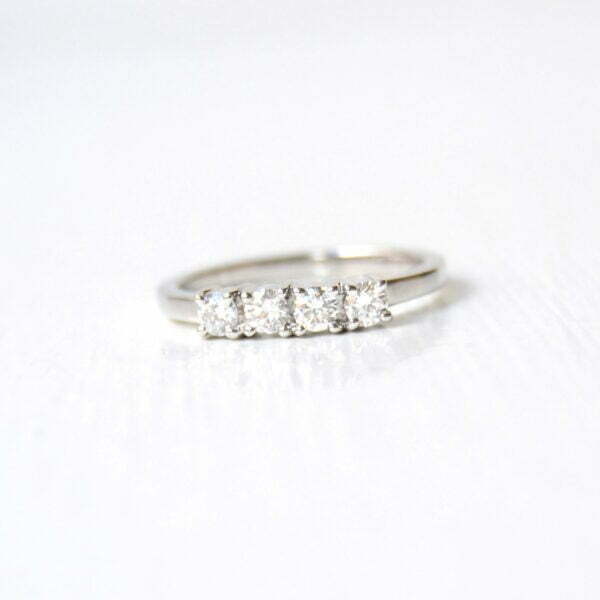 four stone diamond ring band made of 18K white gold