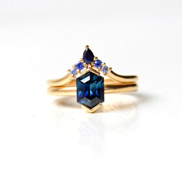 Teal sapphire ring stack of 18K yellow gold.