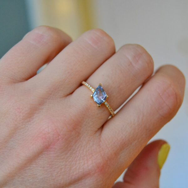 Baby blue sapphire ring with diamonds set in 18K yellow gold.
