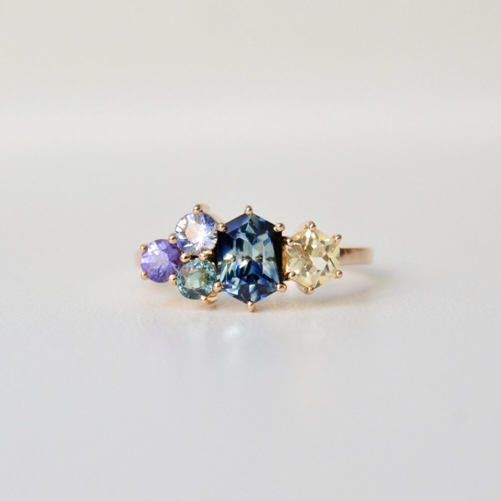 Bi-color sapphire cluster ring set with other sapphires in 18K yellow gold