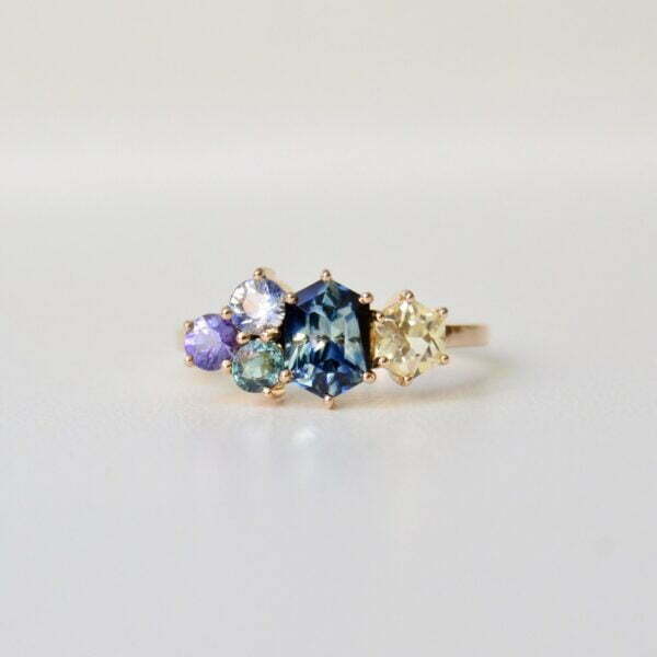 Bi-color sapphire cluster ring set with other sapphires in 18K yellow gold
