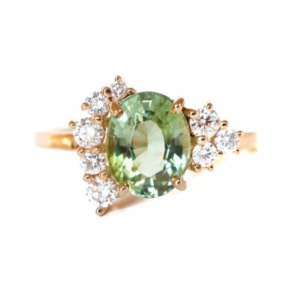 Green tourmaline ring with diamonds set in 18K yellow gold in an asymmetric design